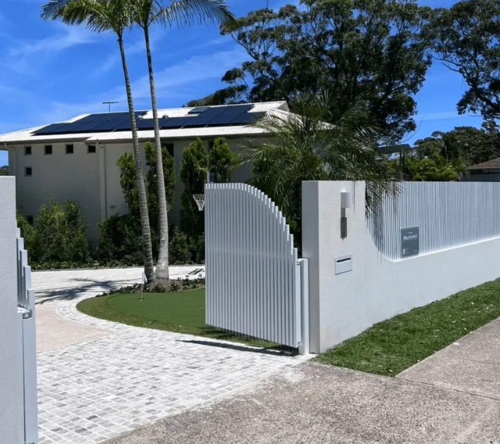 Custom white 40 by 40 aluminium batten fencing and driveway gate